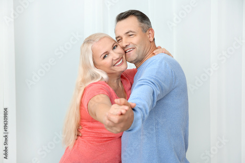 Happy mature couple dancing...