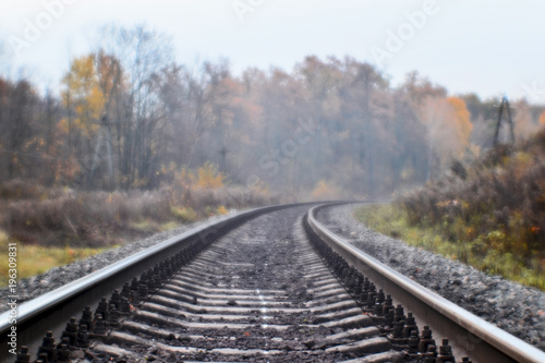 Soft blur photos taken on the soft lens. Railroad in autumn stretches into the distance.
