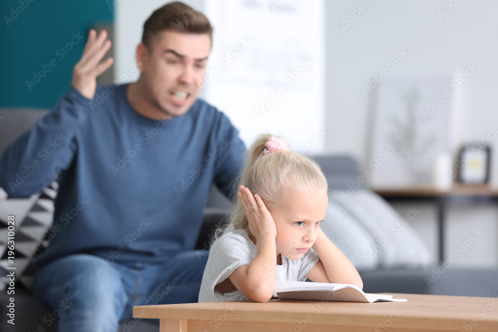 Father scolding his little daughter at home Father scolding his little daughter at home