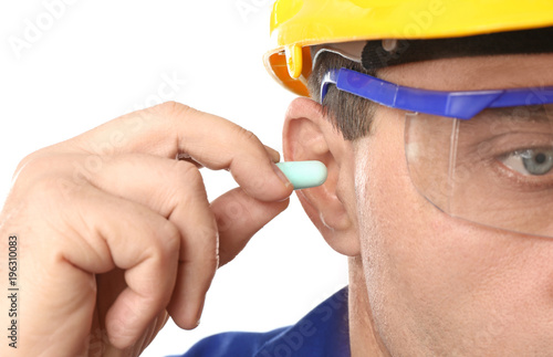 Fotografie Male worker with ear plug, closeup