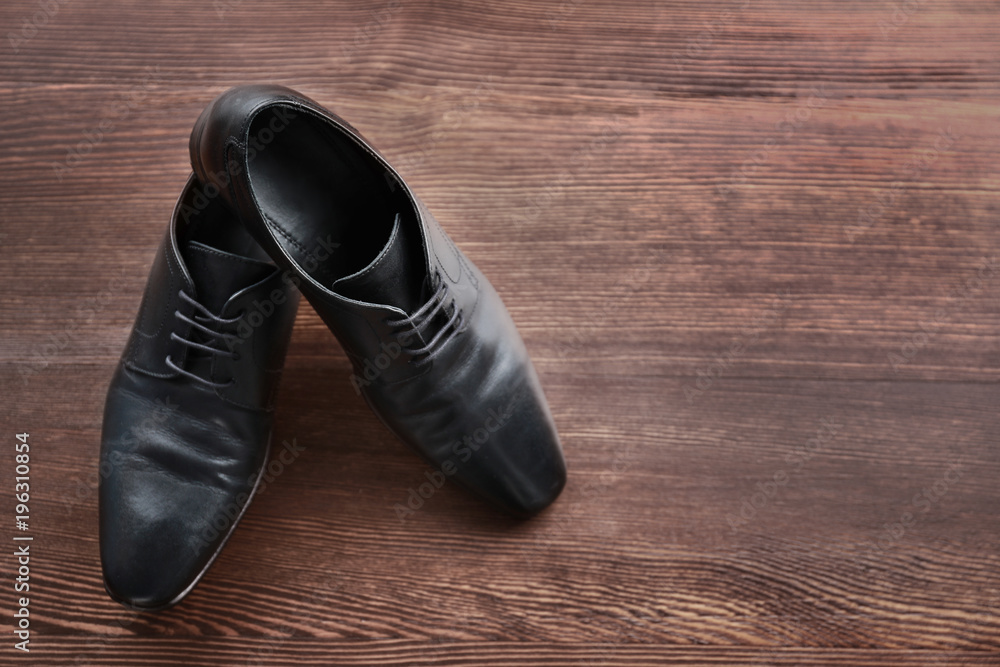 Elegant male shoes on wooden floor