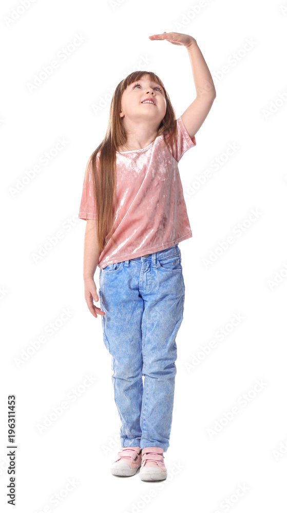 Cute little girl measuring her height on white background Cute little girl measuring her height on white background