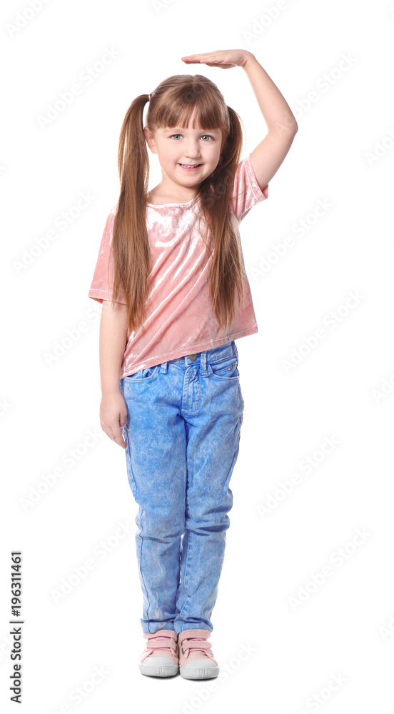 Cute little girl measuring her height on white background Cute little girl measuring her height on white background