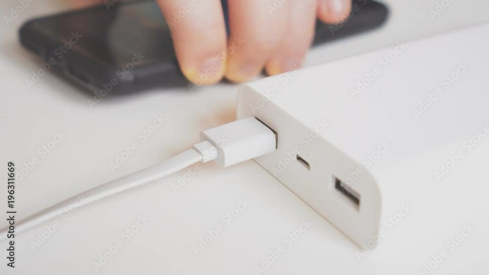Charging smartphone with power bank. Charging smartphone with power bank.