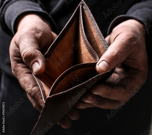 Poor man showing his empty wallet, closeup