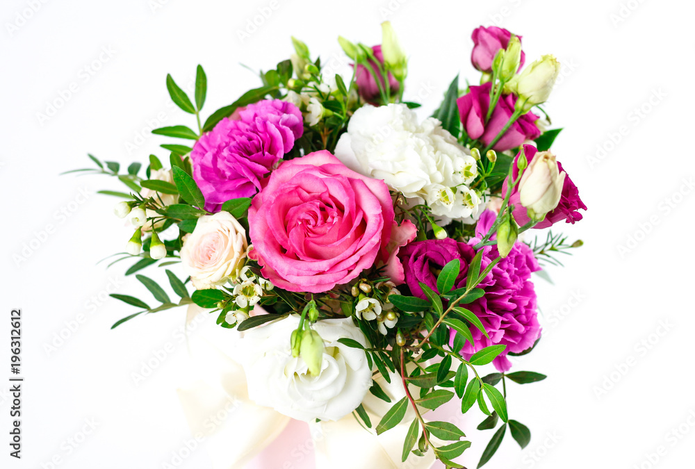Composition of flowers in a pink hatbox. Tied with wide white ribbon and bow