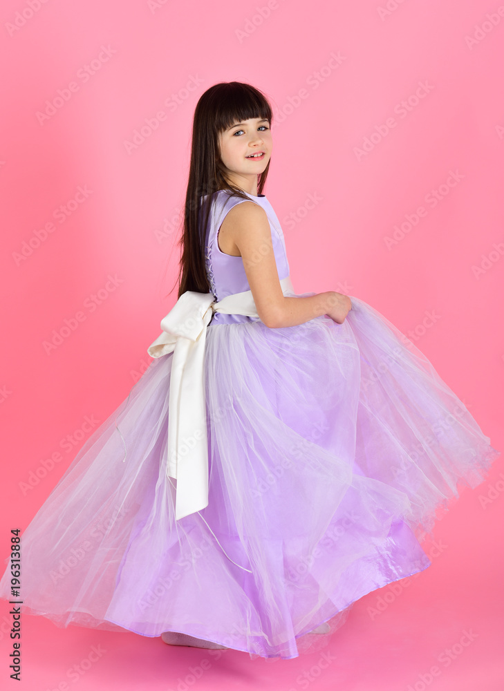 Beautiful little girl model wearing a violet dress Beautiful little girl model wearing a violet dress