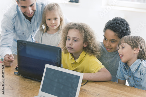 Children working together on laptop