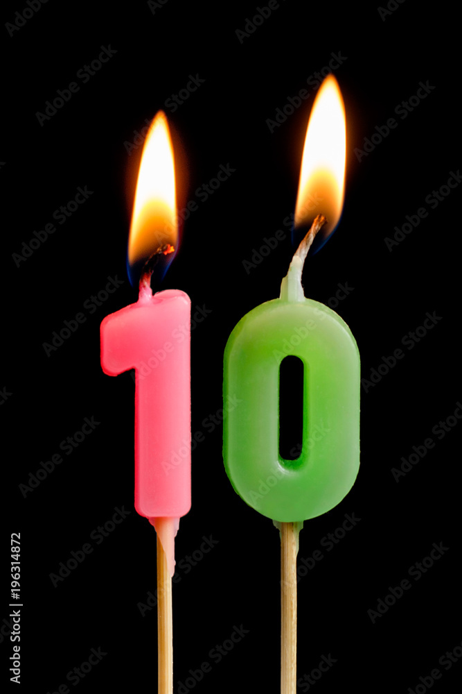Burning candles in the form of ten figures (numbers, dates) for cake isolated on black background. The concept of celebrating a birthday, anniversary, important date, holiday, table setting Burning candles in the form of ten figures (numbers, dates) for cake isolated on black background. The concept of celebrating a birthday, anniversary, important date, holiday, table setting