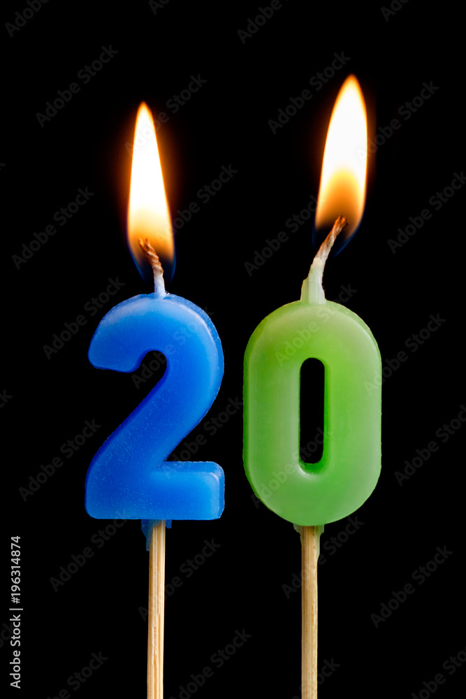 Burning candles in the form of twenty figures (numbers, dates) for cake isolated on black background. The concept of celebrating a birthday, anniversary, important date, holiday, table setting Burning candles in the form of twenty figures (numbers, dates) for cake isolated on black background. The concept of celebrating a birthday, anniversary, important date, holiday, table setting