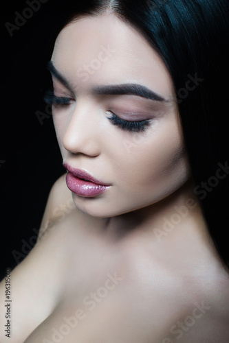 Portrait of a young girl with lush lips and long eyelashes. Perfect fresh young skin.