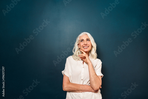 Old cheerful woman looking aside isolated
