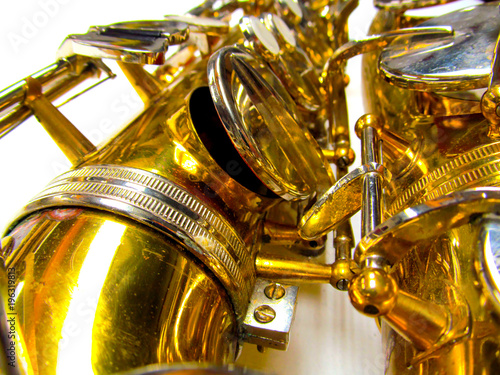 Old golden saxophone close-up. Beautiful vintage shiny brass jazz musical instrument.