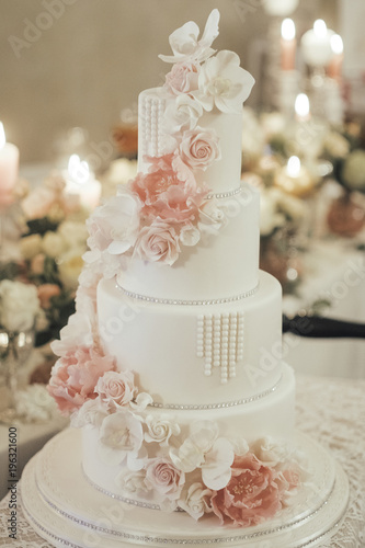 Luxurious wedding cake with marzipan and flower decorations.