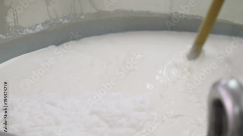 Ricotta cheeese production- mixing milk photo