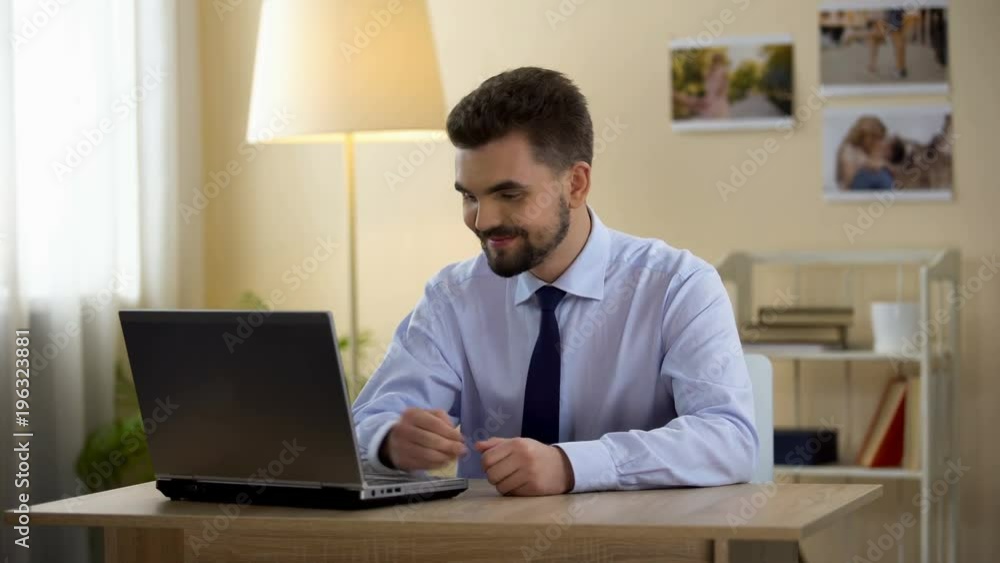 Happy man in business suit sighs with relief after successful interview online Happy man in business suit sighs with relief after successful interview online