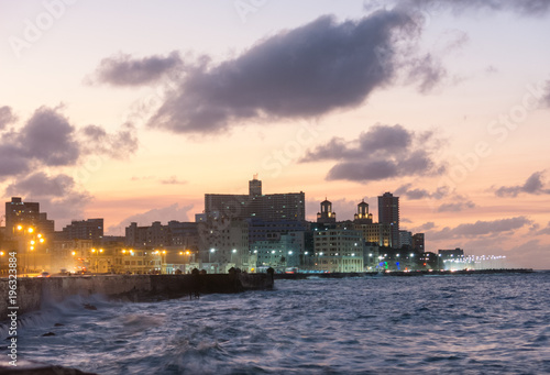 Sunset in the famous malecon (pier, promenade in english) in Havana, Cuba