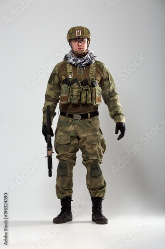 Portrait of full-length soldier with gun in his hand © Sergey