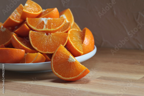 Cut tangerines on wooden table