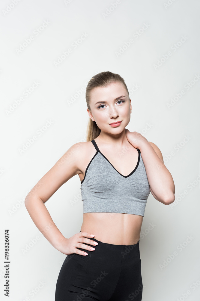 Young woman in sports clothes posing isolated on white Young woman in sports clothes posing isolated on white
