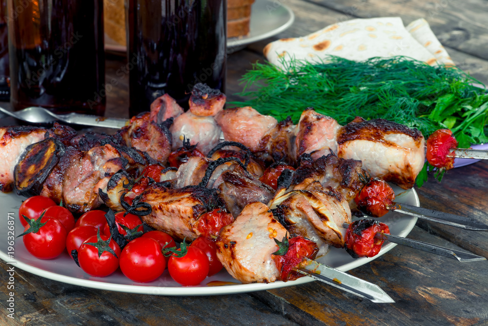 appetizing tasty shish kebab with vegetables on skewers close-up