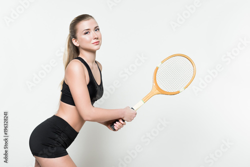 Sportswoman holding tennis racket isolated on white