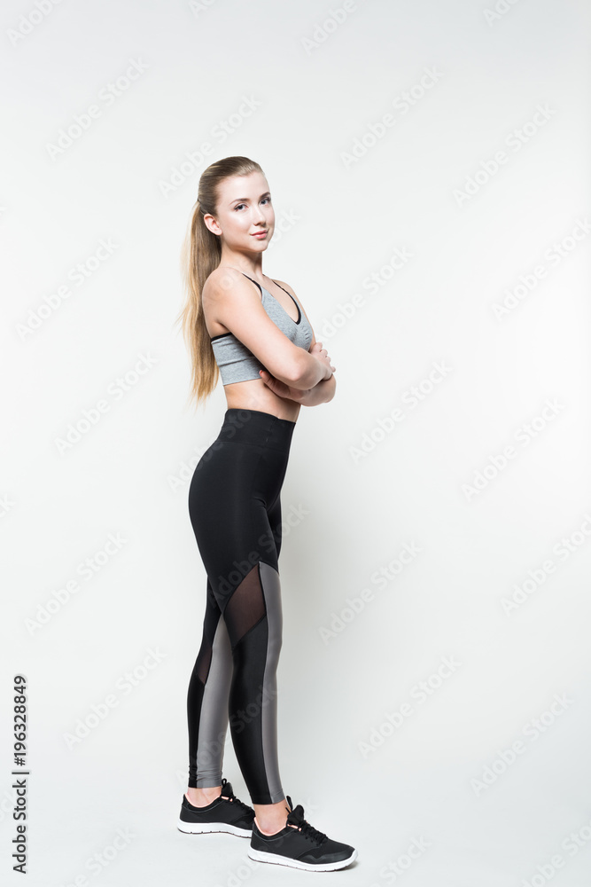 Sportive woman with folded arms isolated on white Sportive woman with folded arms isolated on white