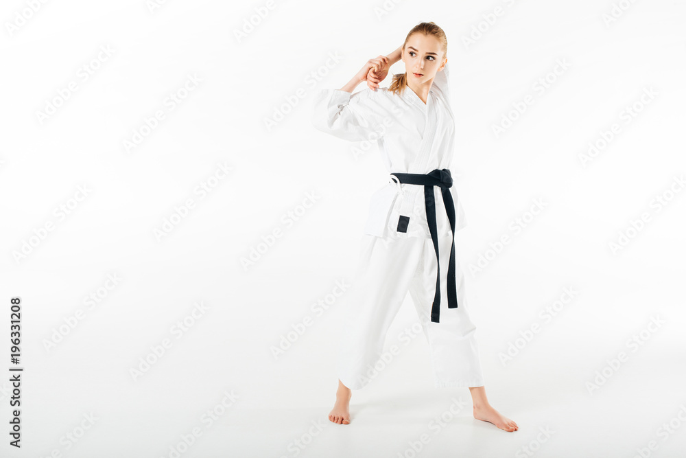 female karate fighter stretching hands isolated on white female karate fighter stretching hands isolated on white