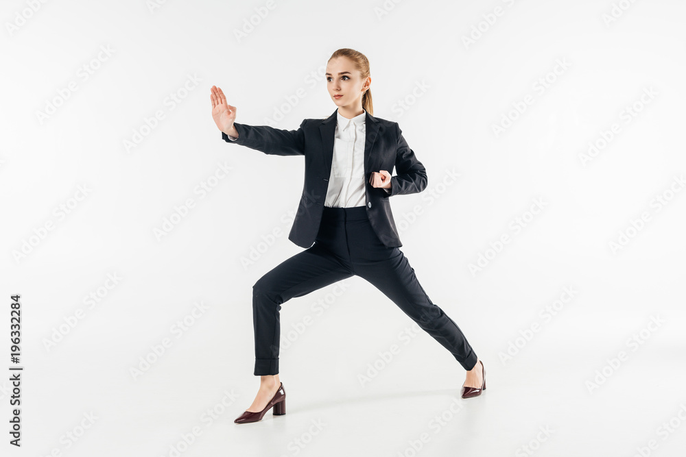 businesswoman exercising karate in suit isolated on white
