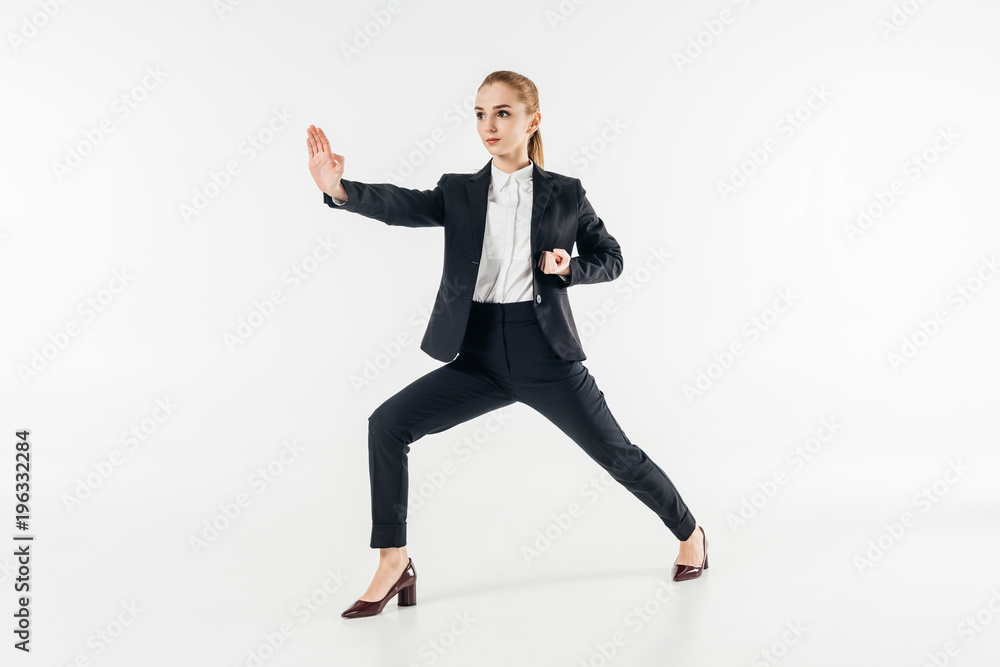 businesswoman exercising karate in suit isolated on white businesswoman exercising karate in suit isolated on white