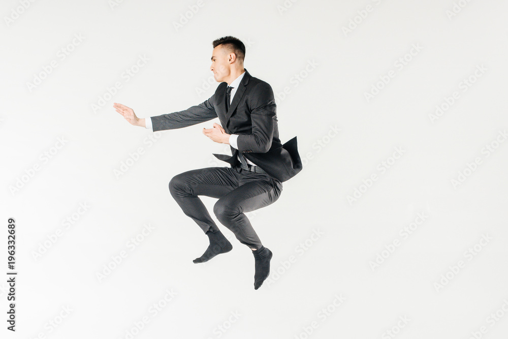 male karate fighter jumping in suit isolated on white male karate fighter jumping in suit isolated on white