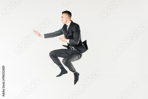 male karate fighter jumping in suit isolated on white © LIGHTFIELD STUDIOS