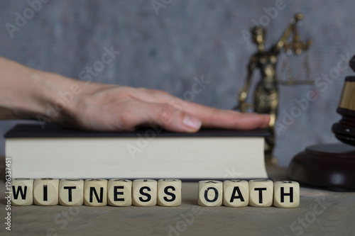Word WITNESS OATH composed of wooden letters.