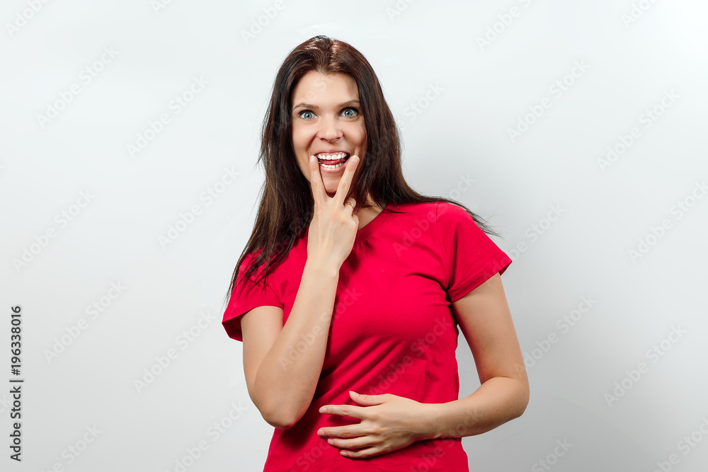 Young, beautiful girl showing a gesture tongue between two fingers. Isolated on a light background. Different human emotions, feelings of facial expression, attitude, perception, body language Young, beautiful girl showing a gesture tongue between two fingers. Isolated on a light background. Different human emotions, feelings of facial expression, attitude, perception, body language