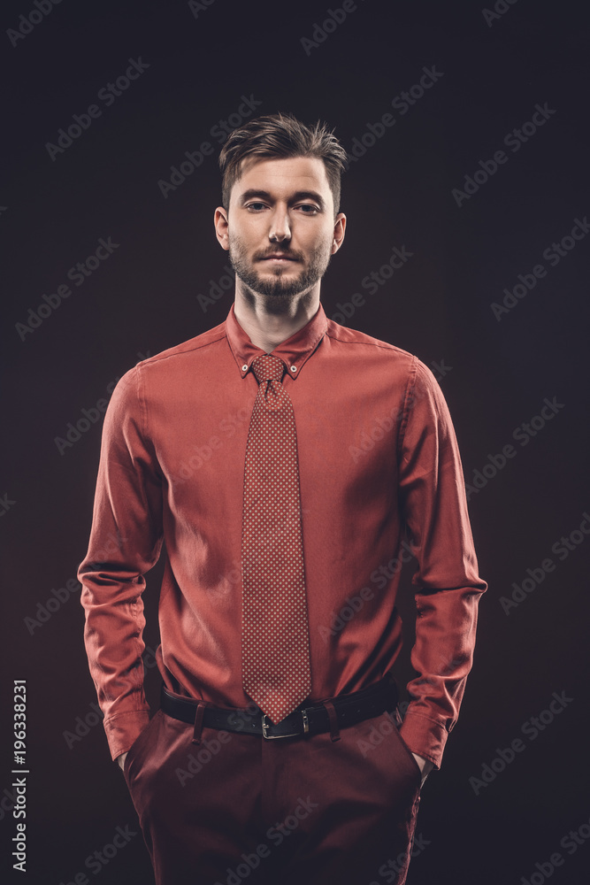 Obraz premium Confident man in red shirt isolated on black