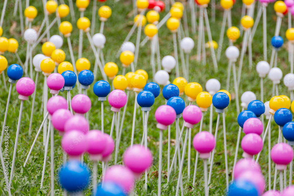Many multi-colored plastic balls on legs Many multi-colored plastic balls on legs