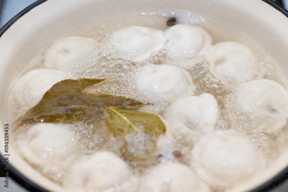 dumplings are cooked in a saucepan with pepper and Bay leaf dumplings are cooked in a saucepan with pepper and Bay leaf
