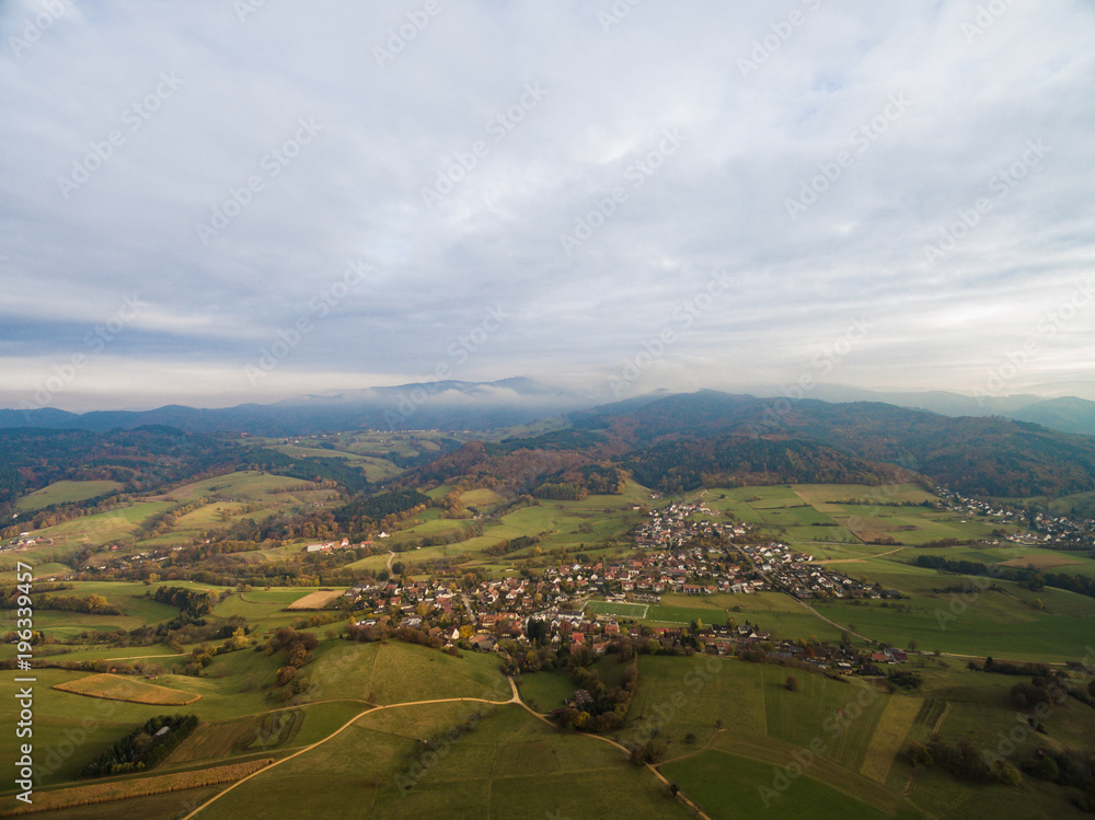 Obraz premium aerial view of beautiful green hills, trees and buildings, Germany