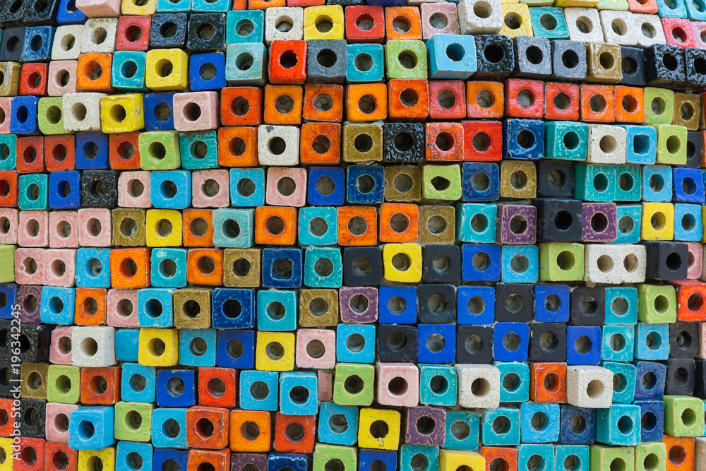 Colorful brick wall surface with a square hole in the middle, made of ceramic background abstract. Colorful brick wall surface with a square hole in the middle, made of ceramic background abstract.