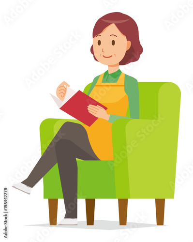A middle-aged housewife wearing an apron is reading on a sofa