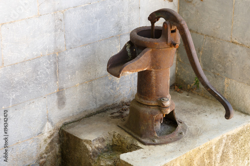 Ancient rusty pump for water supply