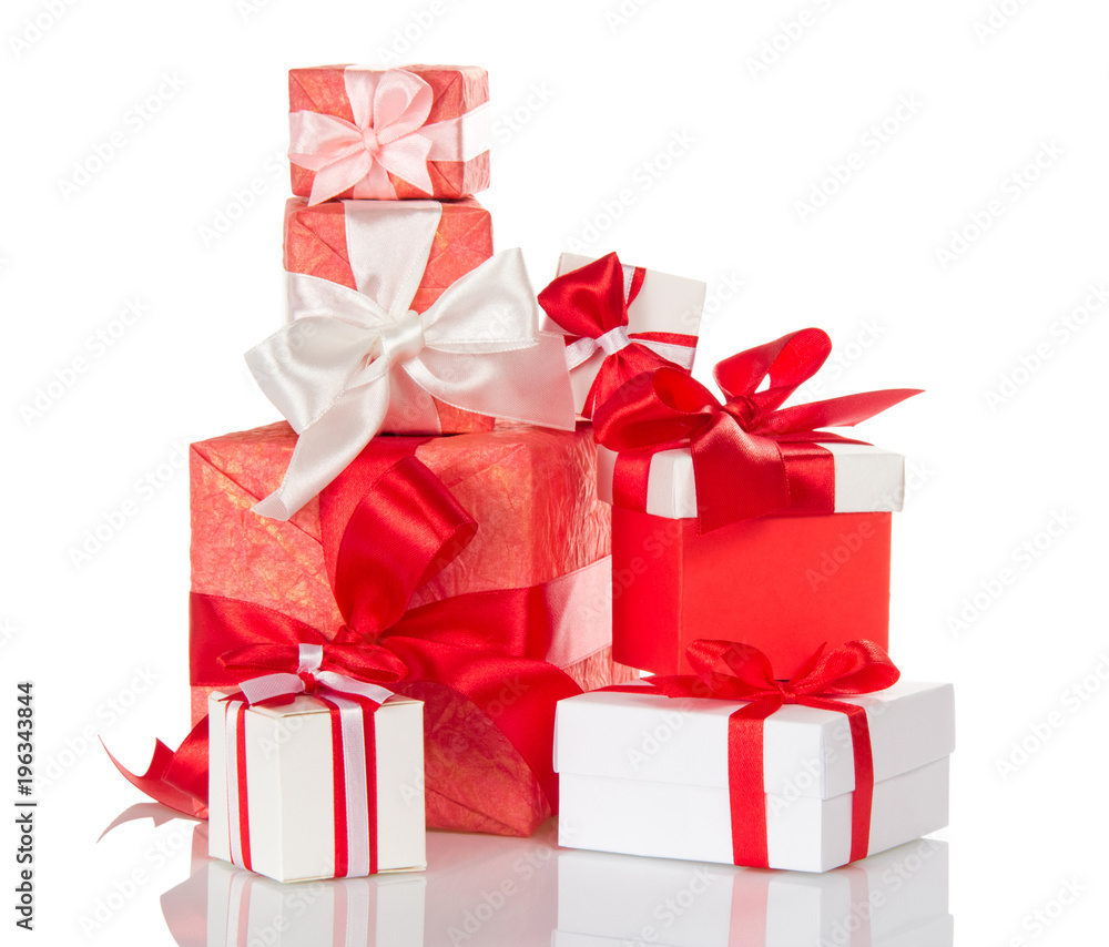 Fototapeta premium Heap of bright gift boxes decorated with red and white bows isolated on white