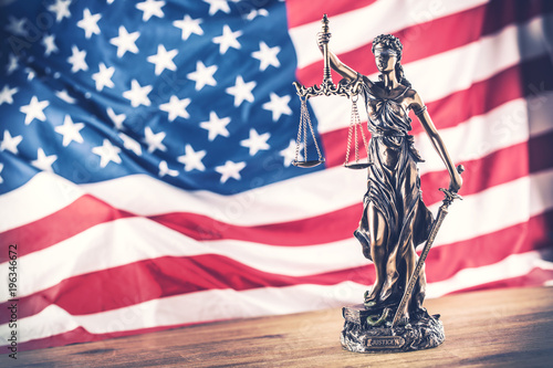 Lady Justice and American flag. Symbol of law and justice with USA Flag photo