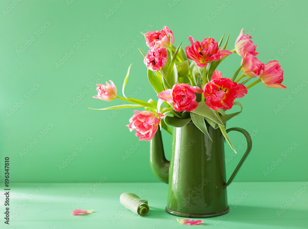 beautiful pink tulip flowers bouquet in green tea pot