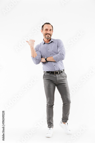 Happy handsome adult businessman pointing.