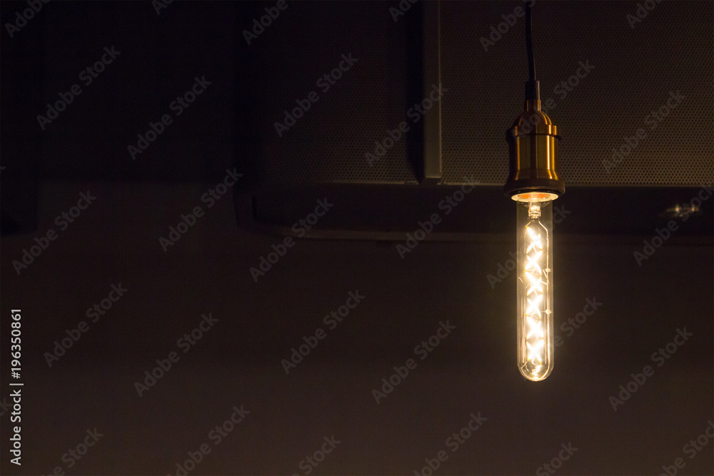 retro light bulb hangs from ceiling near counter bar in dark room, tungsten light  lamp decoration Stock Photo | Adobe Stock
