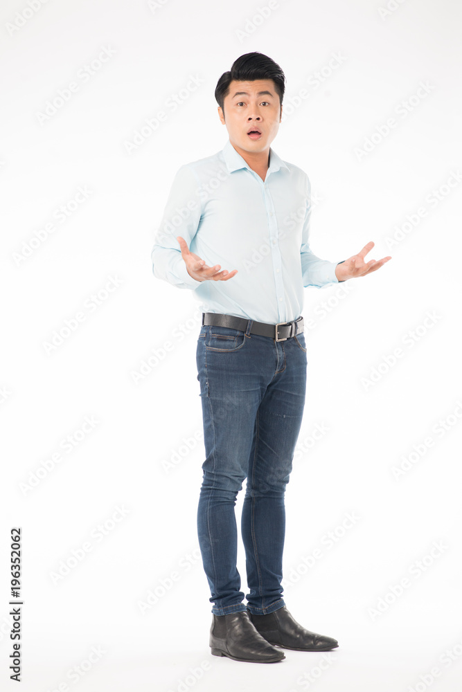 Studio portrait of young Asian man expressing emotions on white background