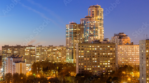 October 2017, Moscow, Russia - night aerial view of modern high rise residential buildings surrounded by autumn pak