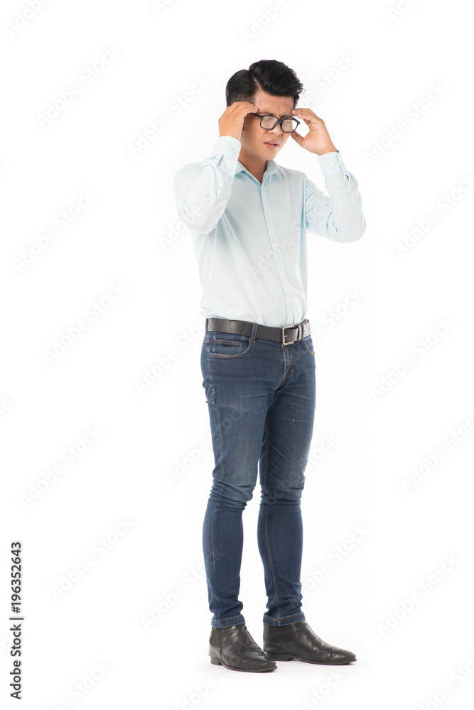 Full length portrait of young Asian man suffering from headache isolated on white Full length portrait of young Asian man suffering from headache isolated on white