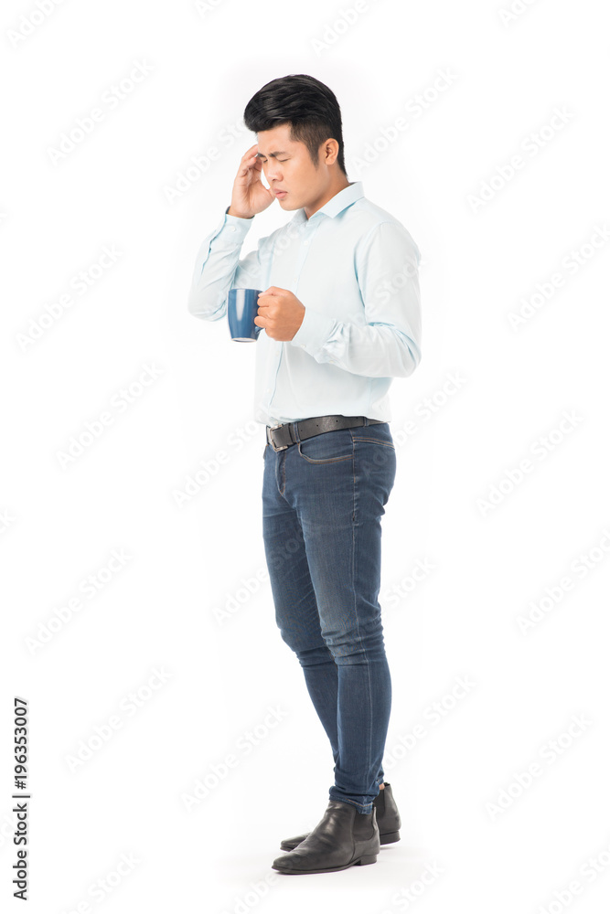 Young Asian man holding mug with hot drink on white background Young Asian man holding mug with hot drink on white background